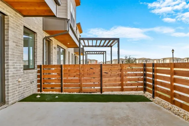 a view of a brick building next to a yard