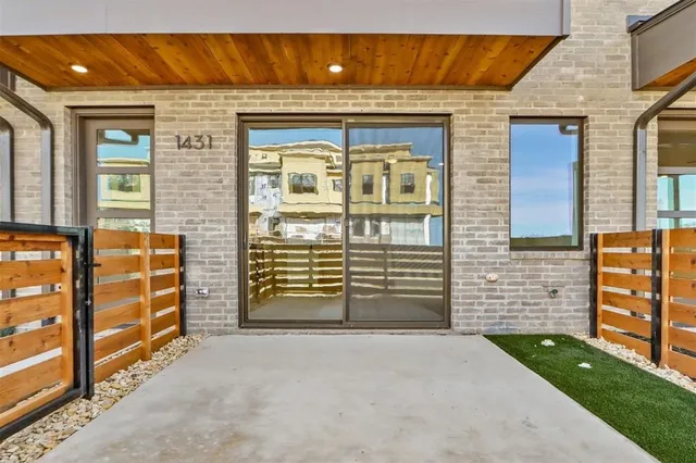 front view of a brick house with large windows