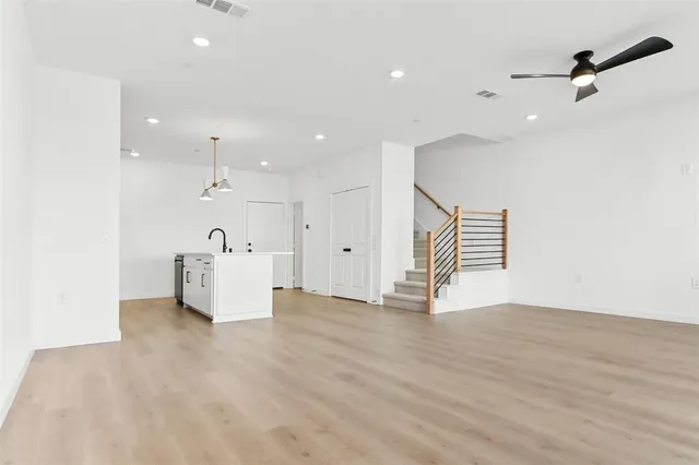a view of an empty room with a cabinet and a window