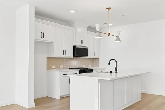 a kitchen with a refrigerator and a sink