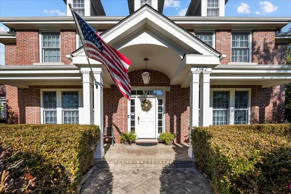 a hallway with wooden floor windows and livingroom view