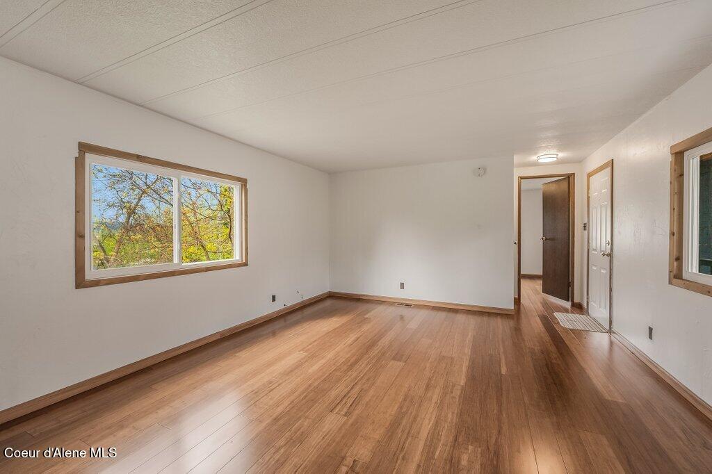 7331 Apache Street Bonners Ferry, ID 83805 - Photo 5 of 23 Living room with filtered views of river