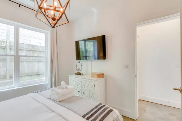 a bedroom with a bed and a window