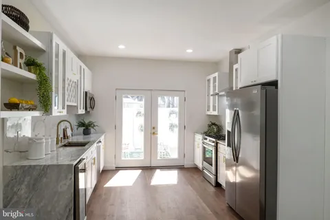a kitchen with a refrigerator and a sink