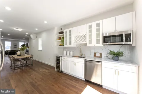 a kitchen with microwave a stove and cabinets