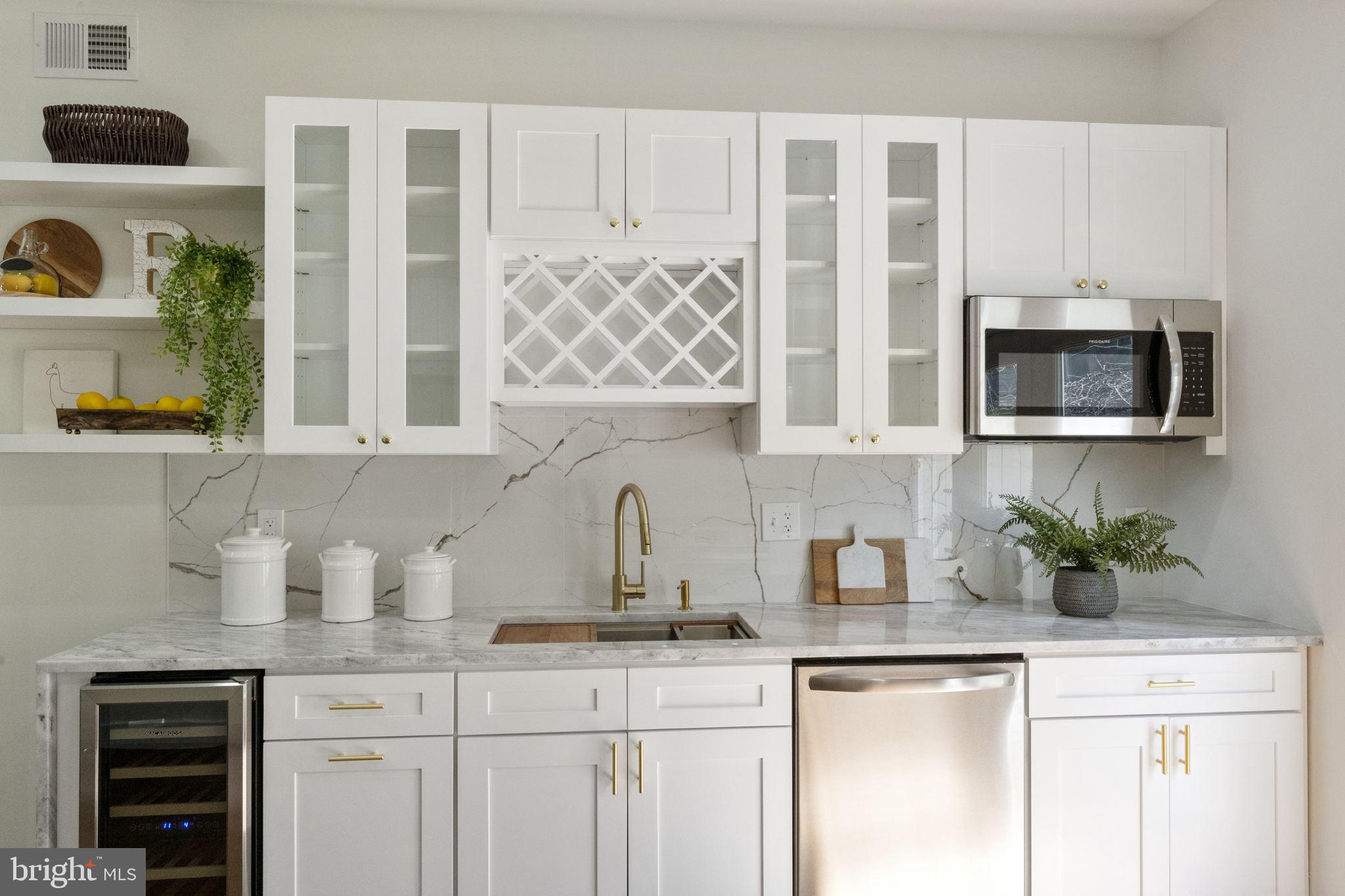 2030 Tasker Street Philadelphia, PA 19145 - Photo 15 of 29 a kitchen with stainless steel appliances granite countertop a sink a microwave and cabinets