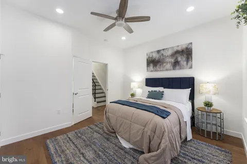 a bedroom with a bed and a painting on the wall