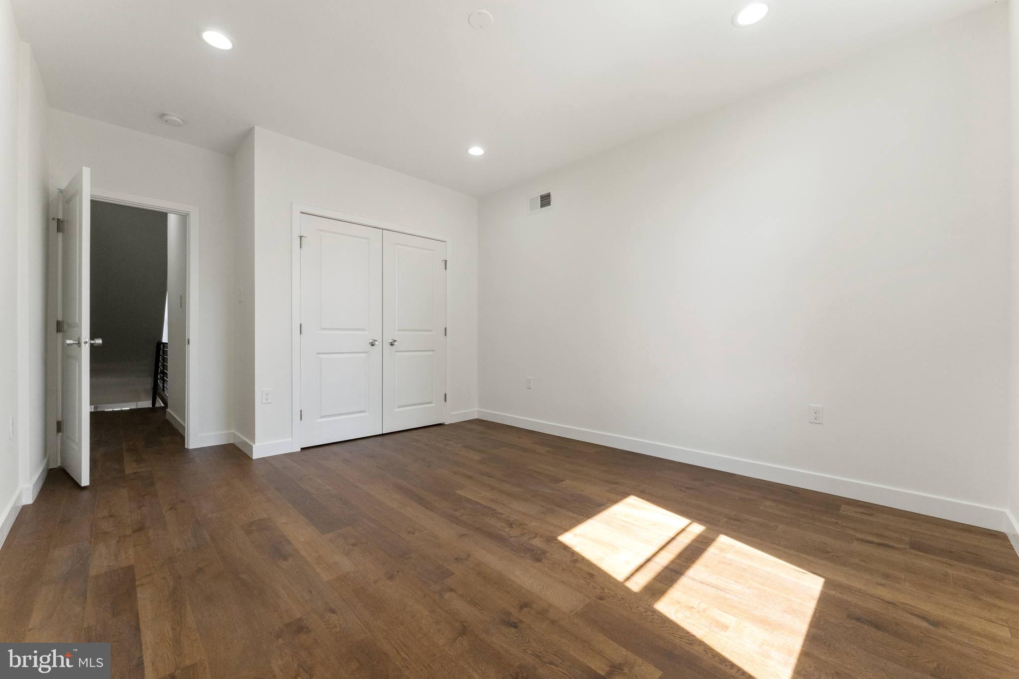 2030 Tasker Street Philadelphia, PA 19145 - Photo 21 of 29 an empty room with wooden floor and natural light
