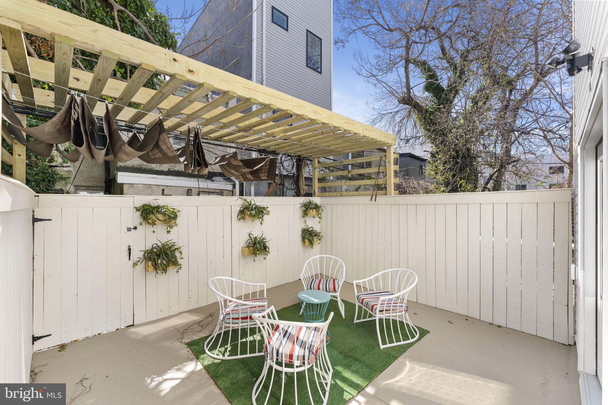 2030 Tasker Street Philadelphia, PA 19145 - Photo 27 of 29 a view of a chair and table in backyard
