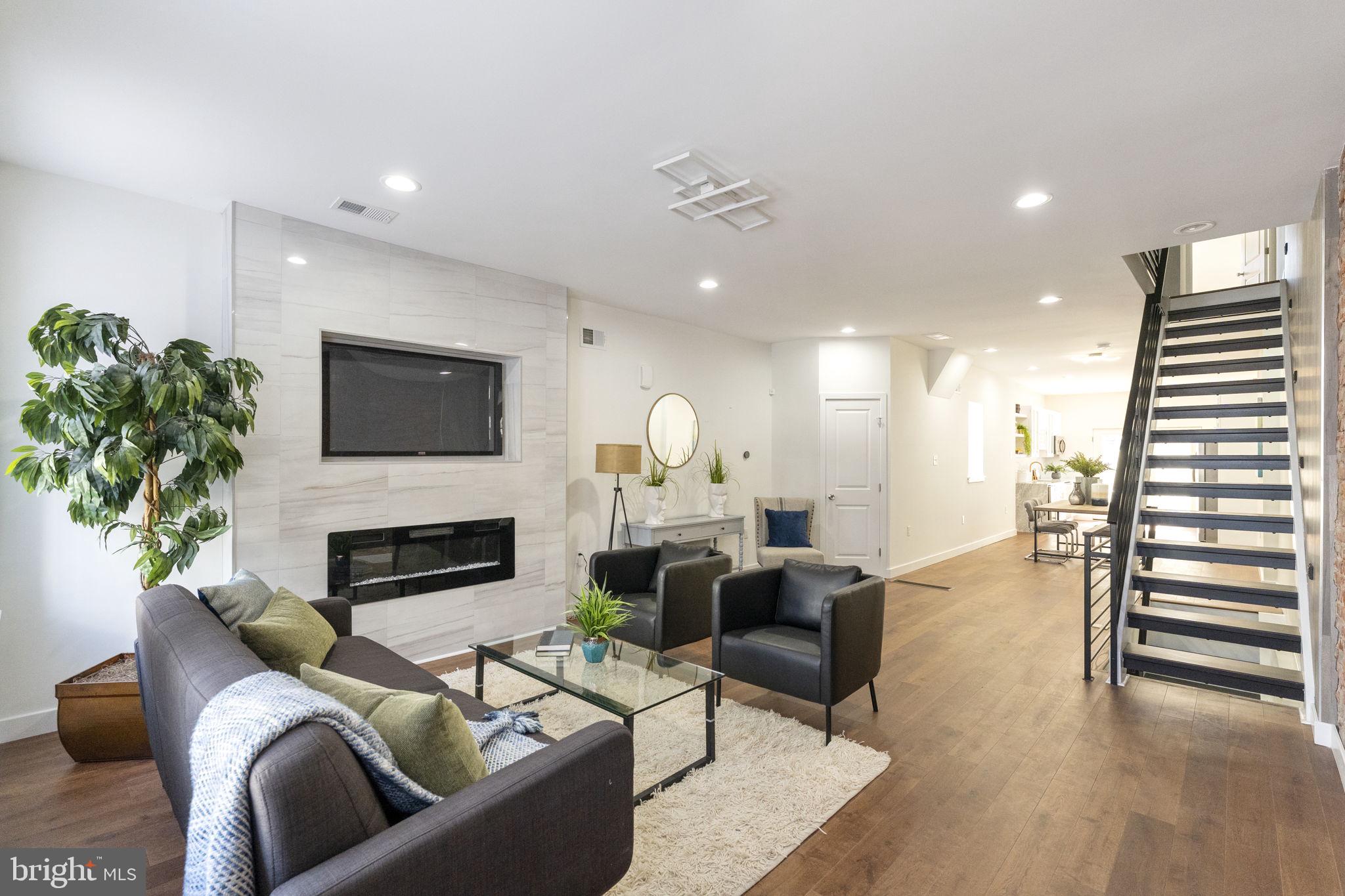2030 Tasker Street Philadelphia, PA 19145 - Photo 8 of 29 a living room with furniture fireplace and potted plants