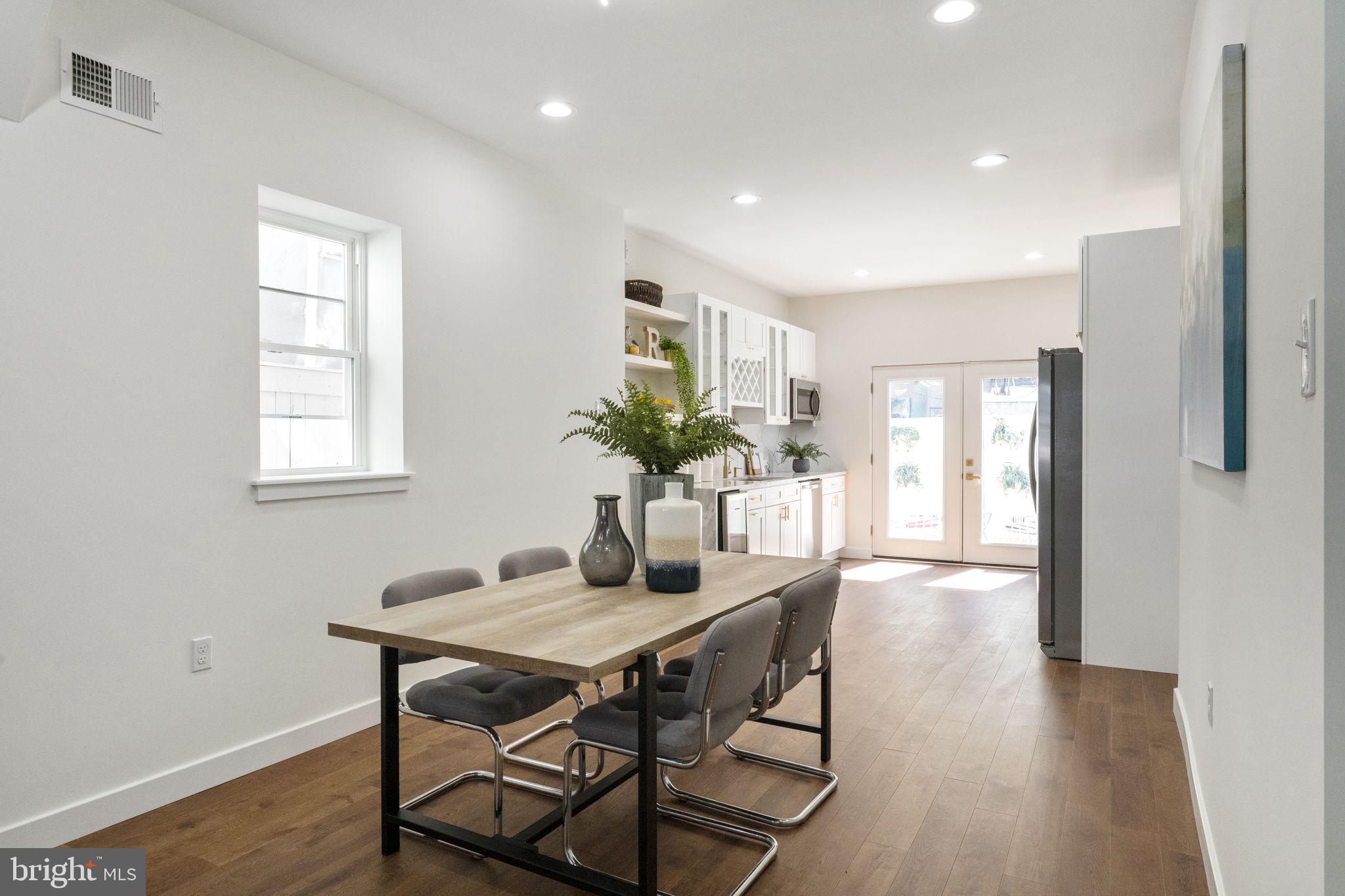 2030 Tasker Street Philadelphia, PA 19145 - Photo 10 of 29 a dining room with furniture and wooden floor