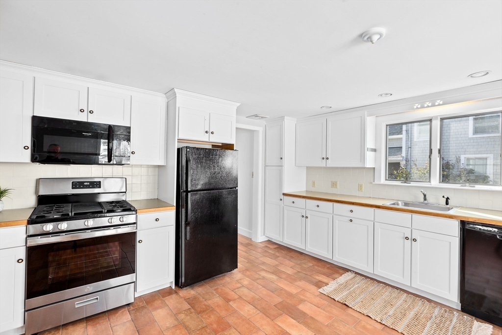 50 Collier Road Scituate, MA 02066 - Photo 12 of 41 a kitchen with granite countertop a refrigerator stove and microwave