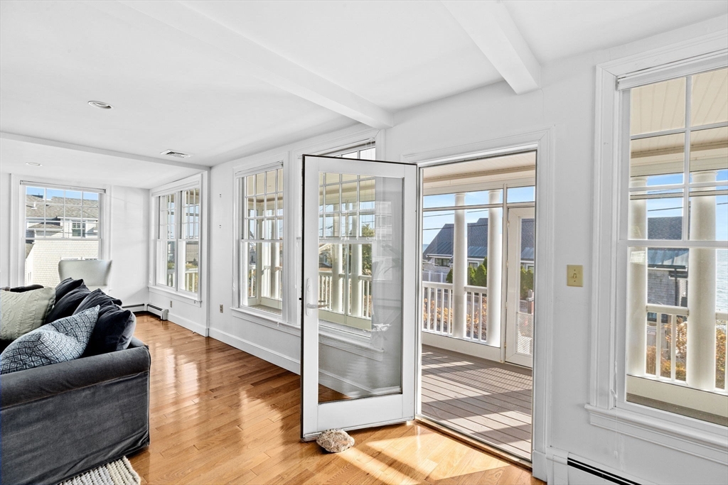 50 Collier Road Scituate, MA 02066 - Photo 18 of 41 a living room with furniture and a floor to ceiling window