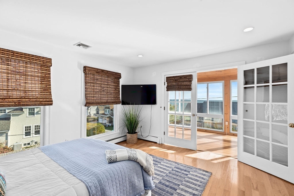 50 Collier Road Scituate, MA 02066 - Photo 22 of 41 a bedroom with a bed and a flat tv screen next to a window