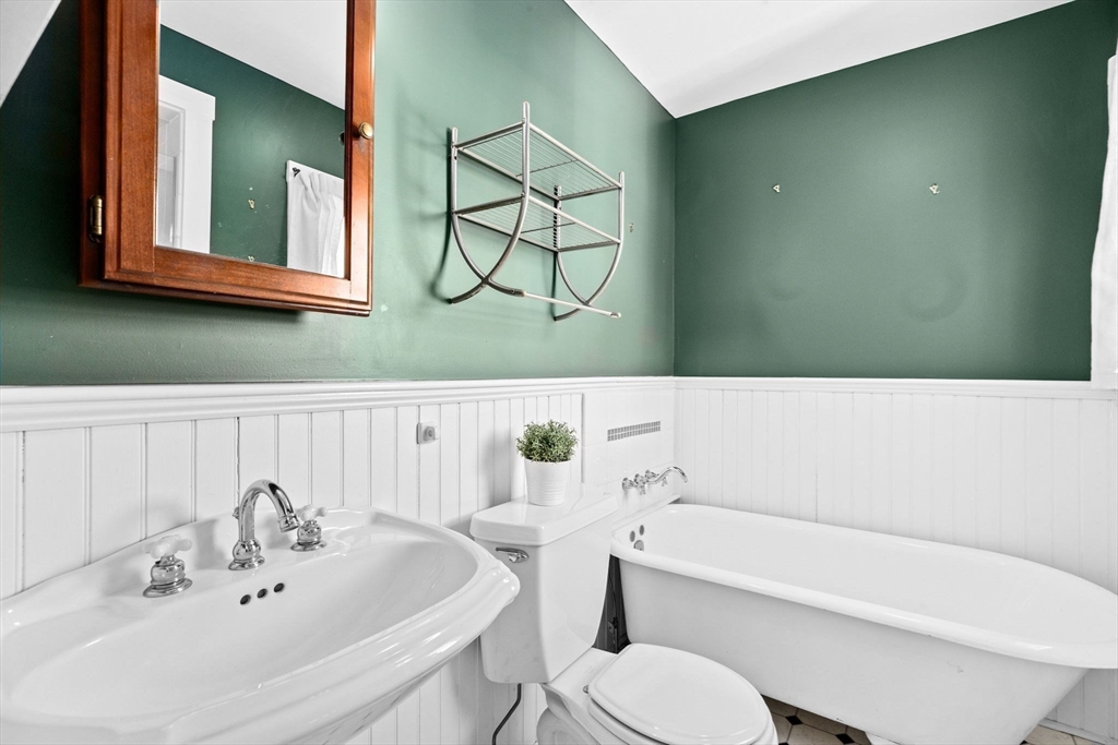 50 Collier Road Scituate, MA 02066 - Photo 25 of 41 a bathroom with a sink a toilet and mirror