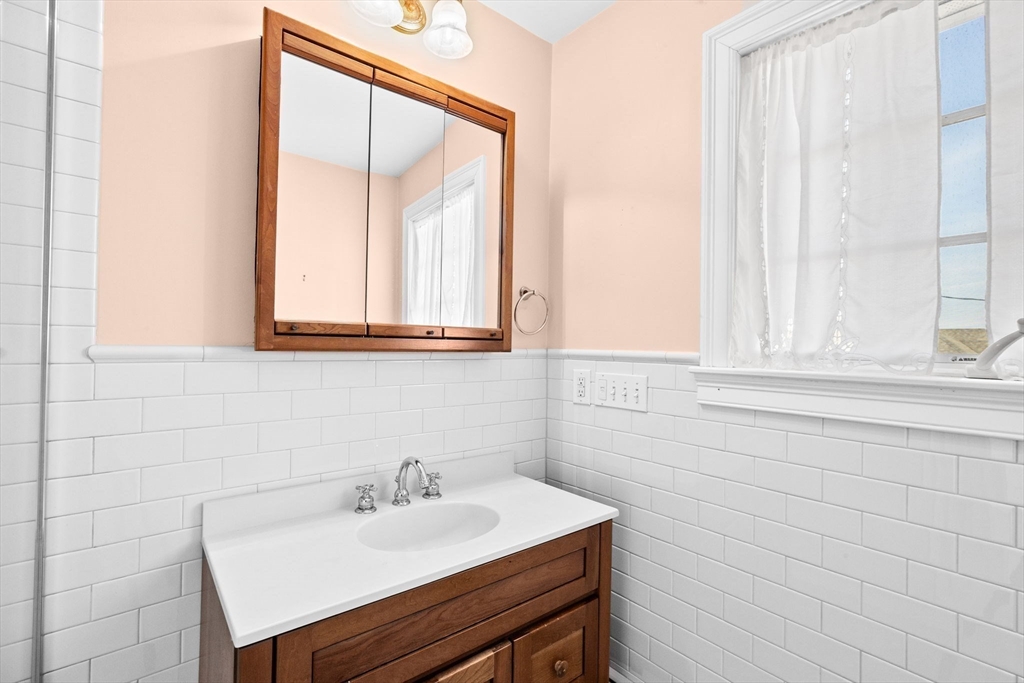 50 Collier Road Scituate, MA 02066 - Photo 28 of 41 a bathroom with a sink and a mirror