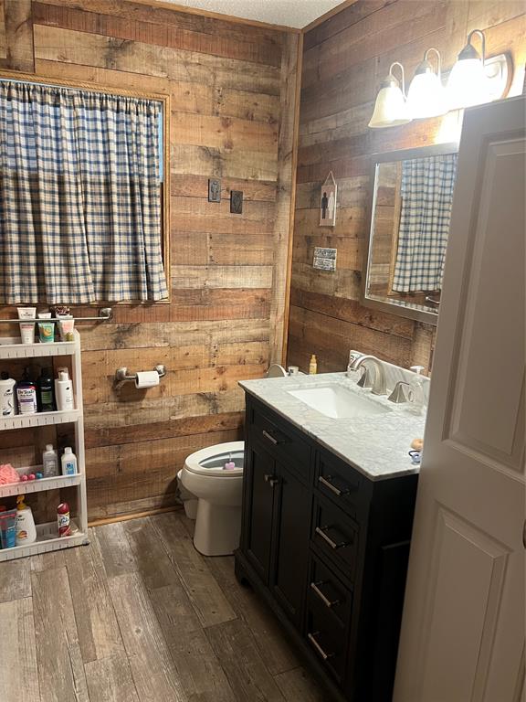 704 East 9th Street Kemp, TX 75143 - Photo 10 of 13 a bathroom with a granite countertop sink a toilet and a mirror