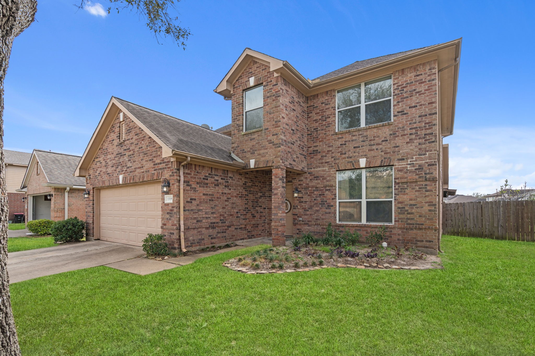 1319 Collier Point Lane Fresno, TX 77545 - Photo 2 of 33 This angled exterior perspective highlights the home’s elegant design, generous driveway space, and thoughtfully designed façade that blends comfort with timeless style.