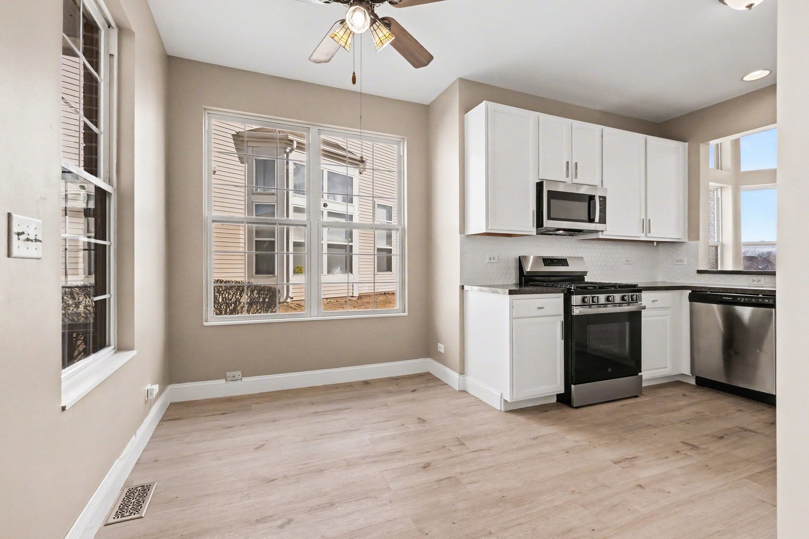 906 Bluebell Circle Joliet, IL 60431 - Photo 2 of 18 a kitchen with stainless steel appliances a stove sink and microwave