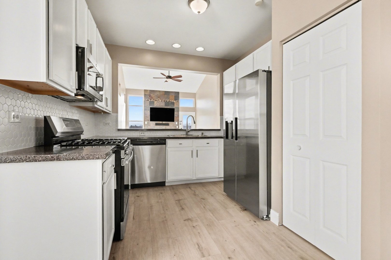 906 Bluebell Circle Joliet, IL 60431 - Photo 3 of 18 a kitchen with stainless steel appliances a sink stove and refrigerator