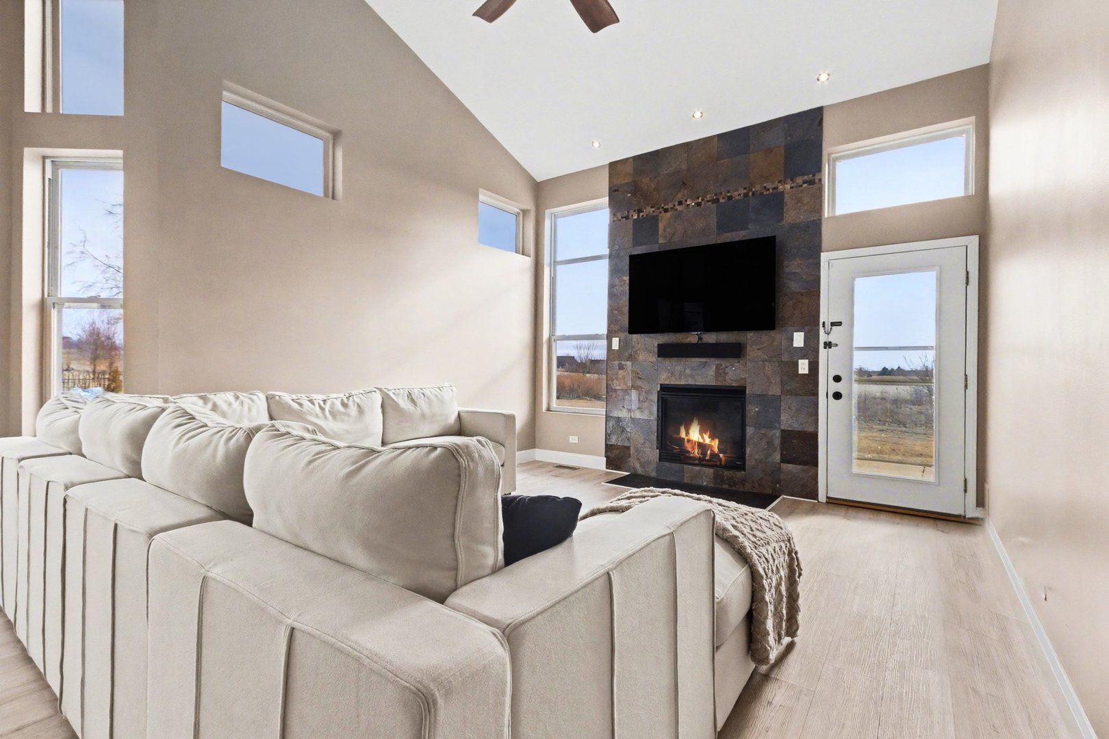 906 Bluebell Circle Joliet, IL 60431 - Photo 5 of 18 a living room with furniture a flat screen tv and a fireplace