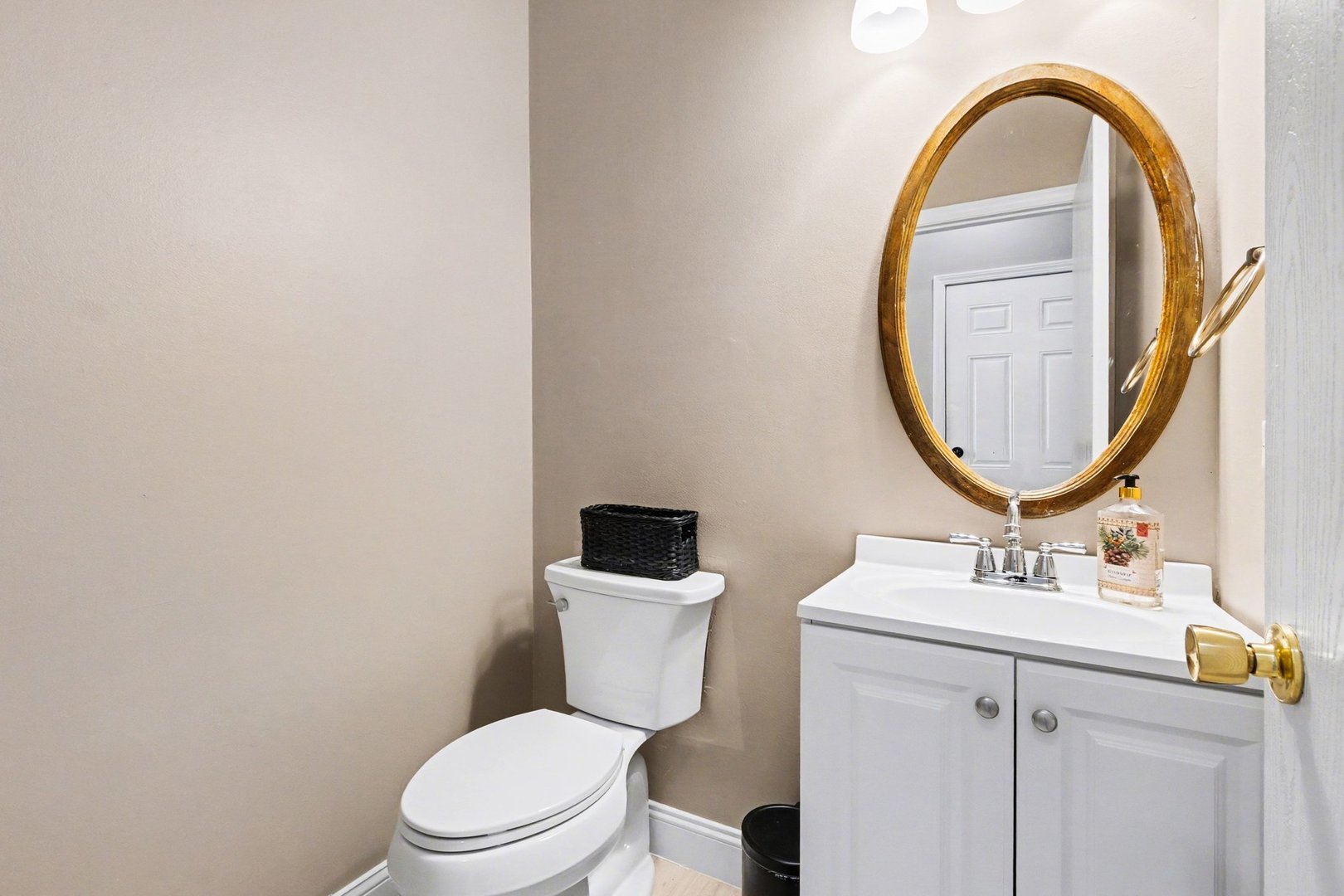 906 Bluebell Circle Joliet, IL 60431 - Photo 6 of 18 a bathroom with a toilet a sink and a mirror