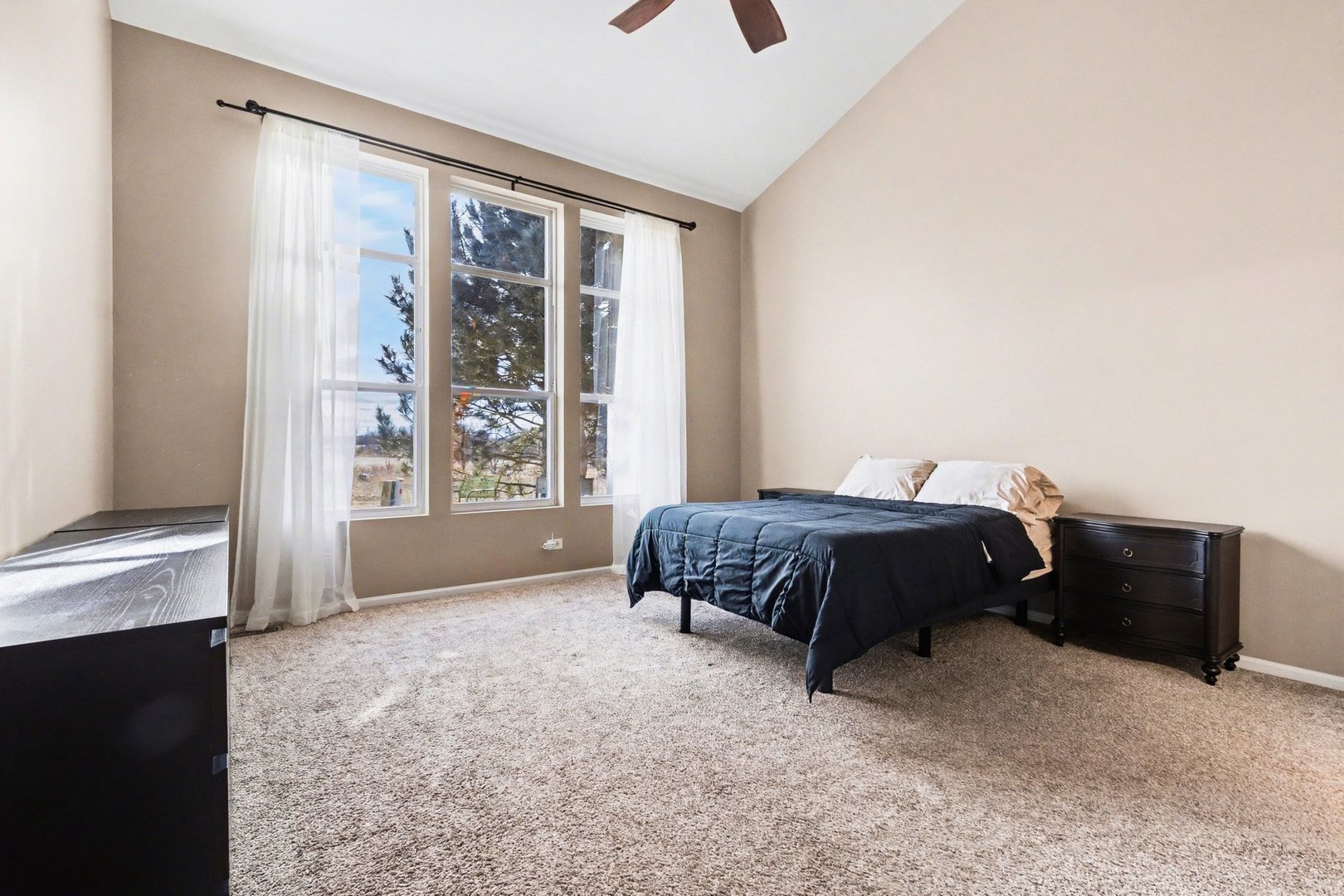 906 Bluebell Circle Joliet, IL 60431 - Photo 7 of 18 a bedroom with a large bed and a large window