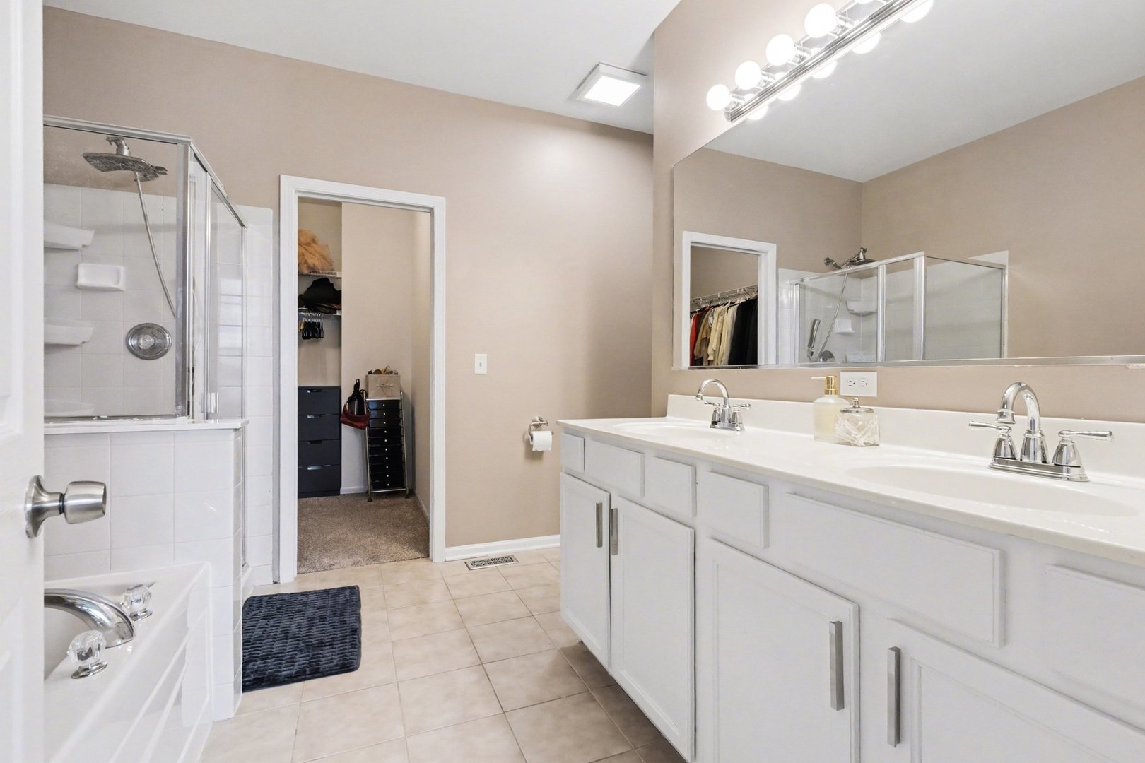 906 Bluebell Circle Joliet, IL 60431 - Photo 8 of 18 a spacious bathroom with a shower a sink and a mirror