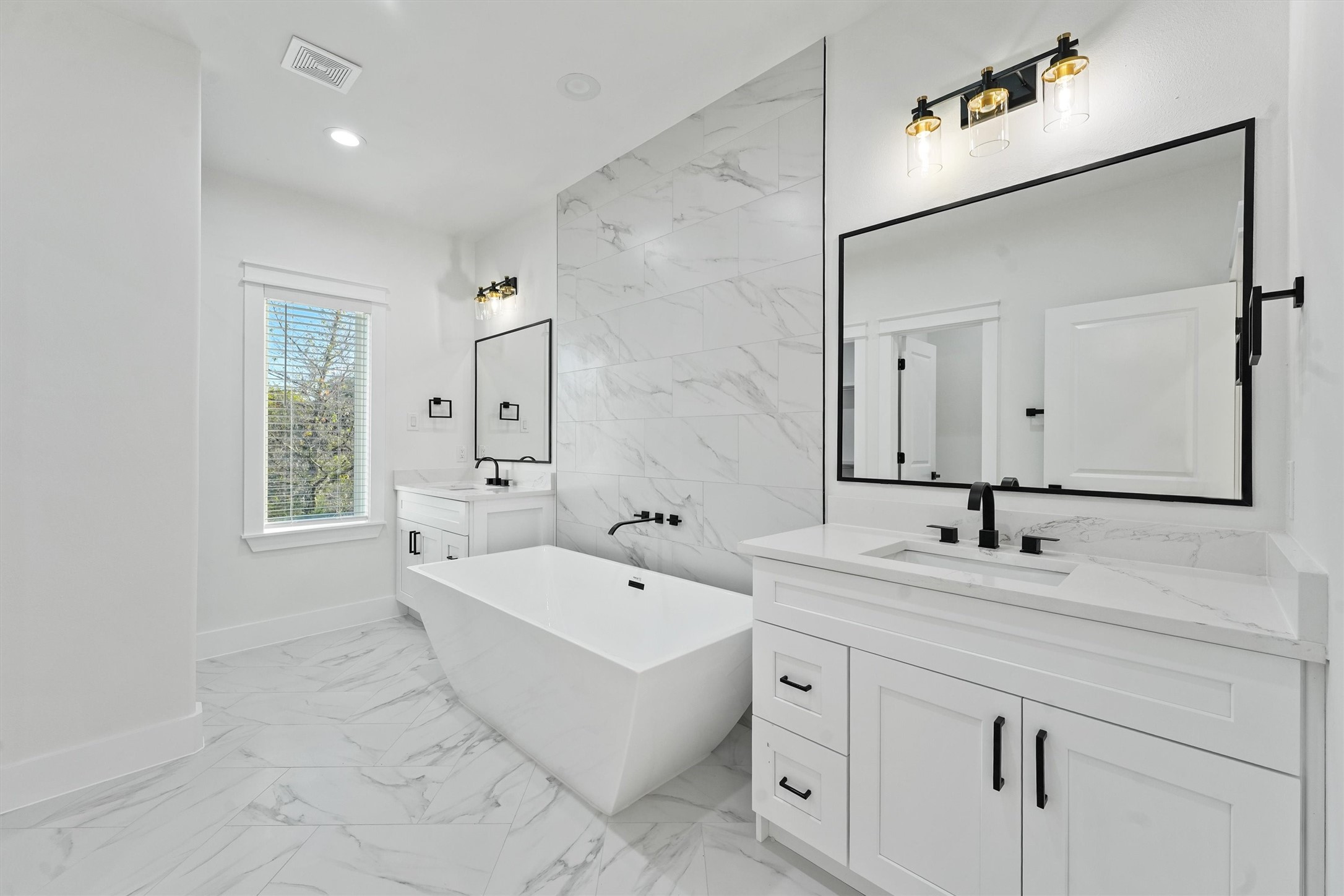 4208 Castor Street, Unit B Houston, TX 77022 - Photo 13 of 23 a spacious bathroom with a double vanity sink mirror and bathtub