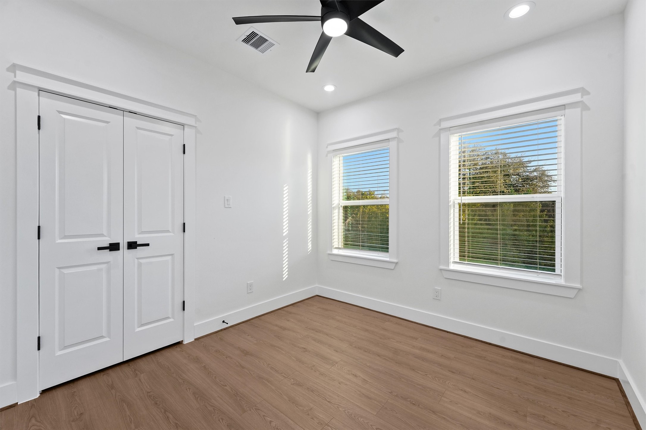 4208 Castor Street, Unit B Houston, TX 77022 - Photo 18 of 23 a view of an empty room with a window and wooden floor