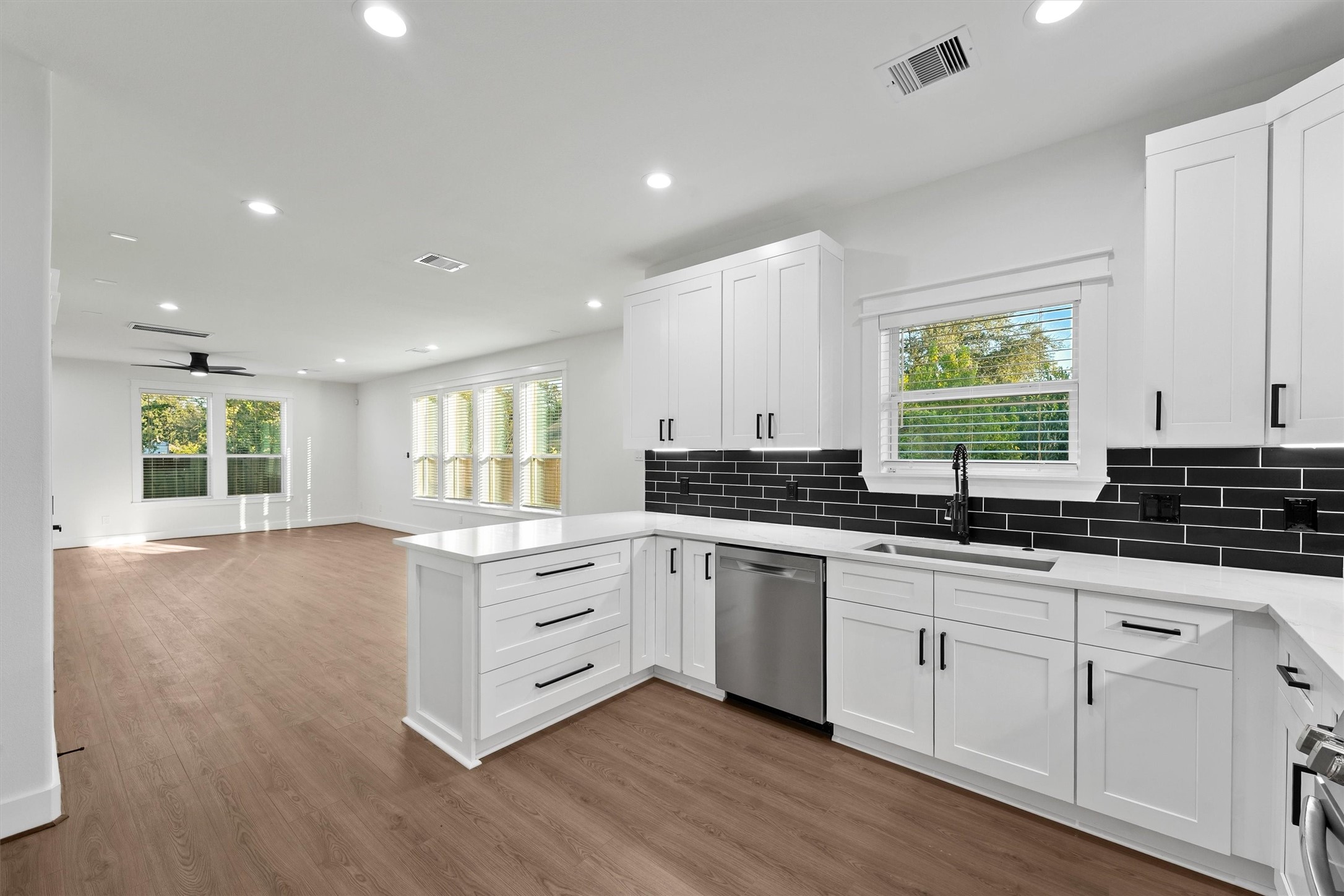 4208 Castor Street, Unit B Houston, TX 77022 - Photo 3 of 23 a kitchen with granite countertop white cabinets and white appliances
