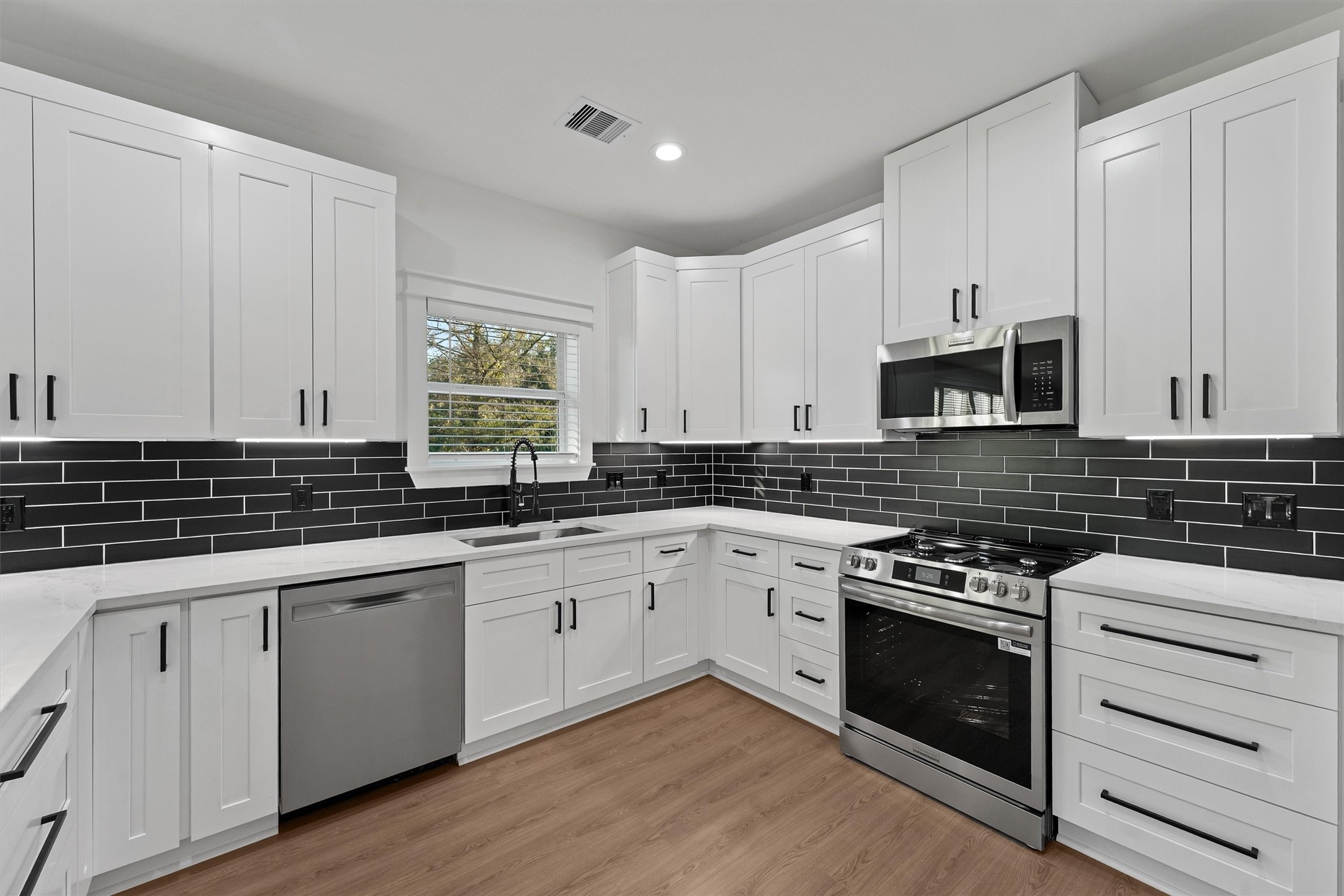 4208 Castor Street, Unit B Houston, TX 77022 - Photo 5 of 23 a kitchen with granite countertop white cabinets and appliances
