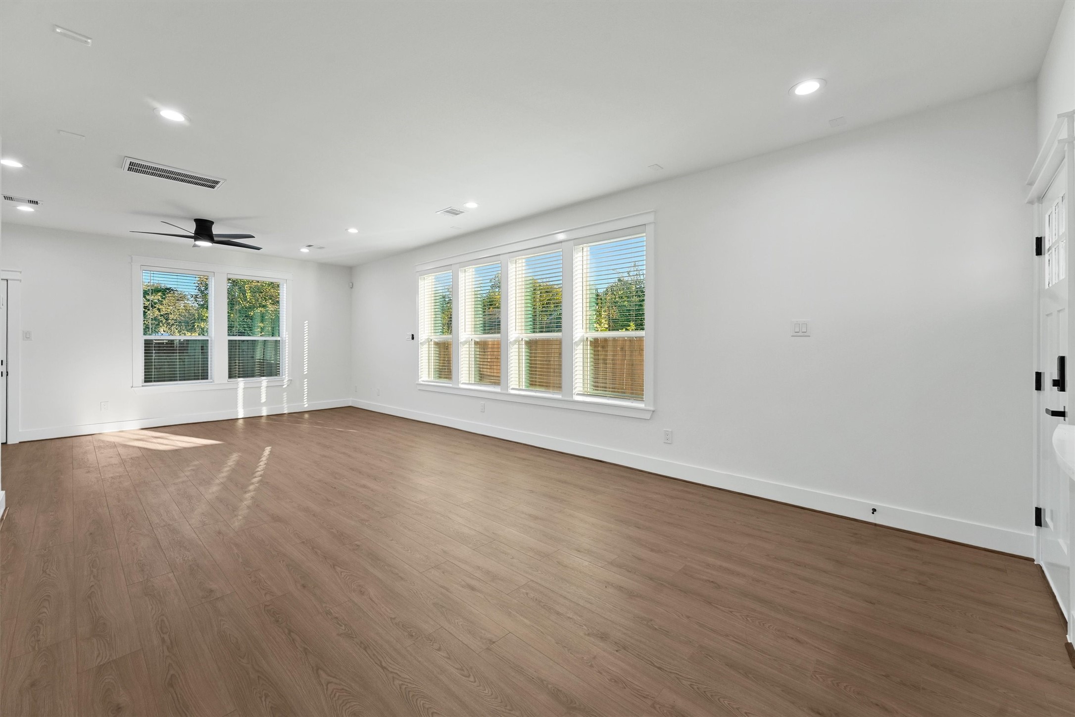 4208 Castor Street, Unit B Houston, TX 77022 - Photo 9 of 23 an empty room with wooden floor and windows