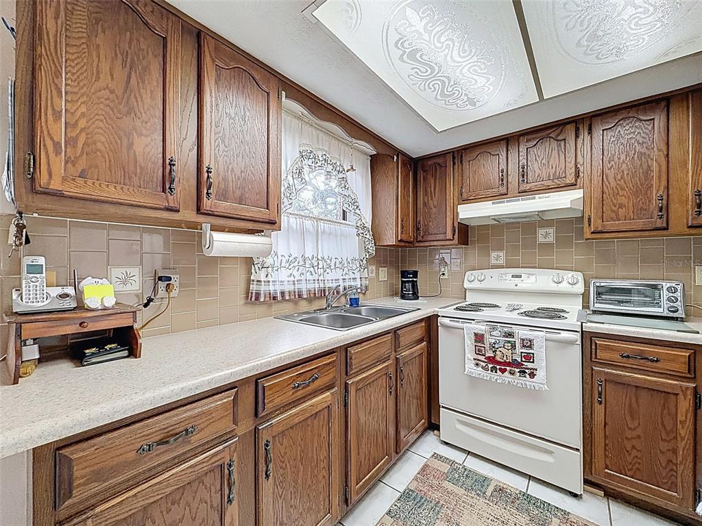 12229 Cedro Street Spring Hill, FL 34609 - Photo 18 of 50 a kitchen with a sink cabinets and window