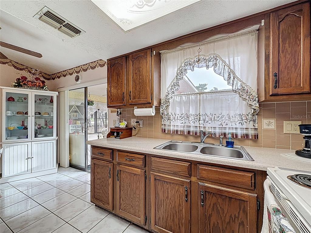 12229 Cedro Street Spring Hill, FL 34609 - Photo 20 of 50 a kitchen with a sink cabinets and window