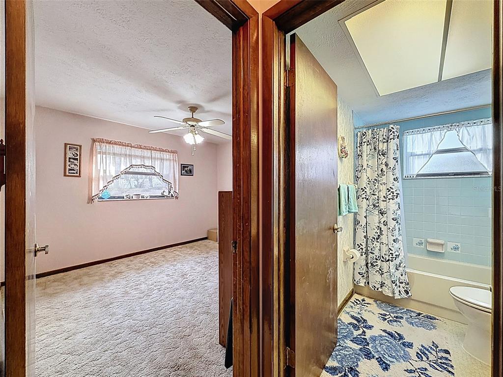 12229 Cedro Street Spring Hill, FL 34609 - Photo 28 of 50 a view of a hallway to a livingroom with furniture and windows
