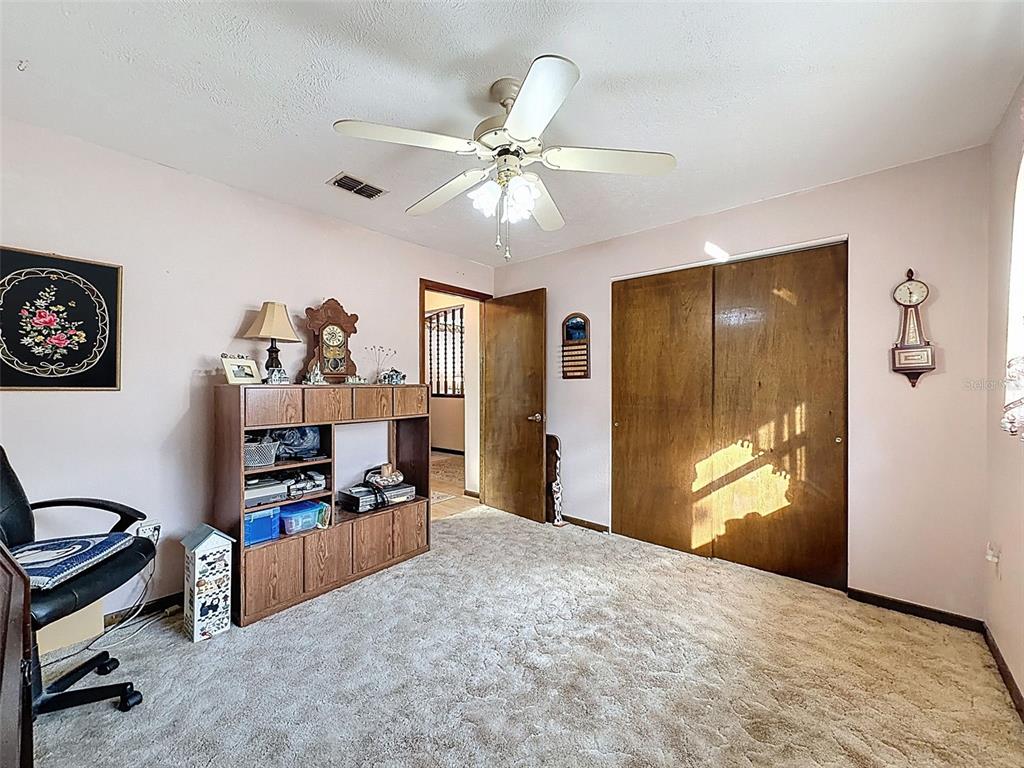 12229 Cedro Street Spring Hill, FL 34609 - Photo 32 of 50 a bedroom with furniture and window