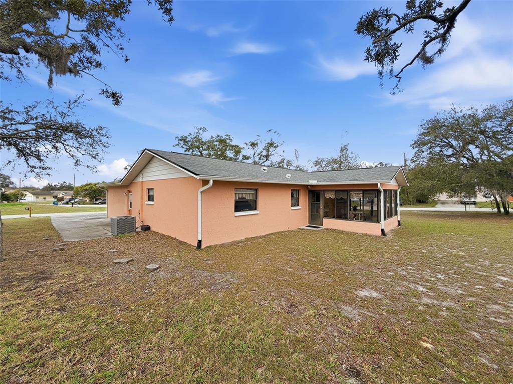 12229 Cedro Street Spring Hill, FL 34609 - Photo 38 of 50 a view of a house with a yard
