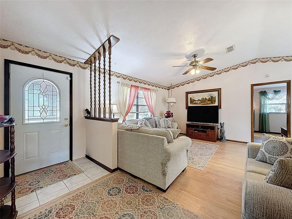 12229 Cedro Street Spring Hill, FL 34609 - Photo 8 of 50 a living room with furniture and a flat screen tv
