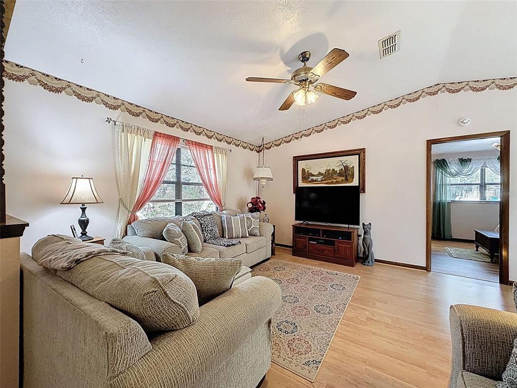 12229 Cedro Street Spring Hill, FL 34609 - Photo 9 of 50 a living room with furniture and a flat screen tv