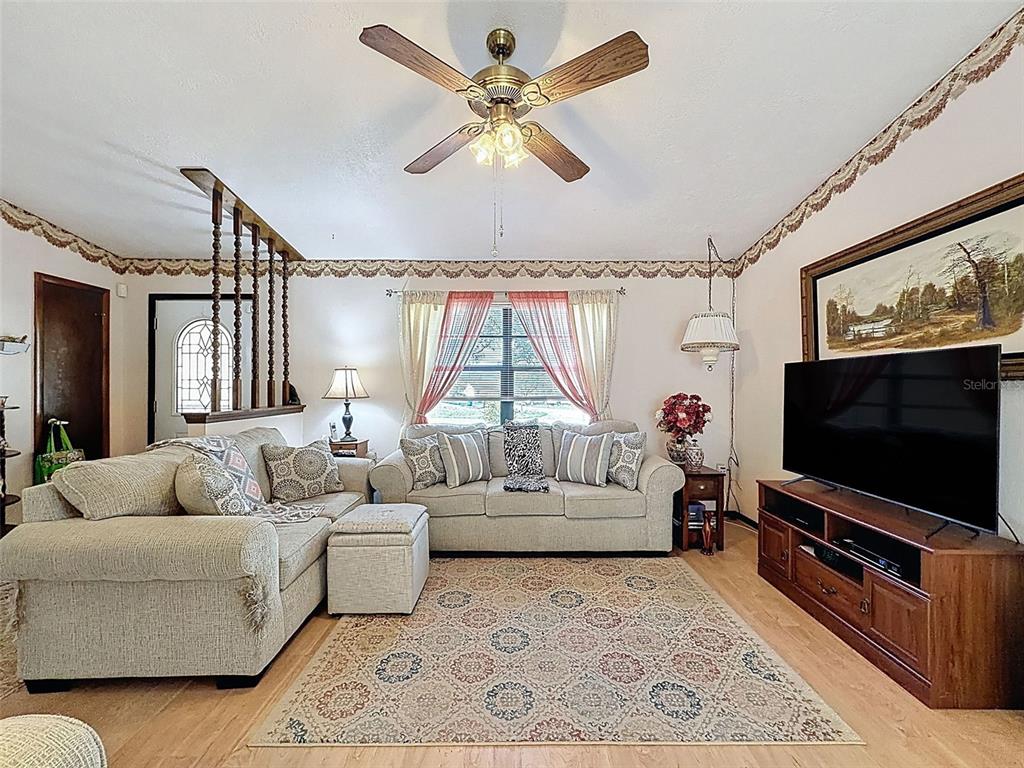 12229 Cedro Street Spring Hill, FL 34609 - Photo 10 of 50 a living room with furniture and a flat screen tv