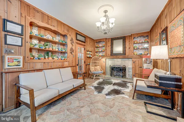 a living room with furniture a fireplace and a large window