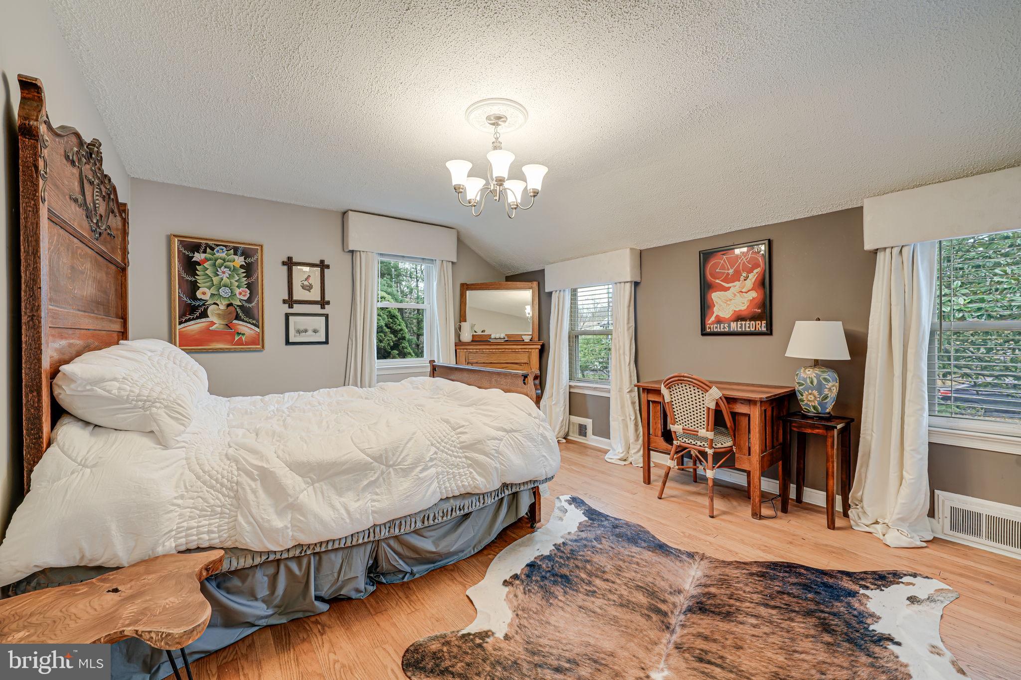 8536 Aponi Road Vienna, VA 22180 - Photo 19 of 40 a spacious bedroom with a bed and dresser with mirror