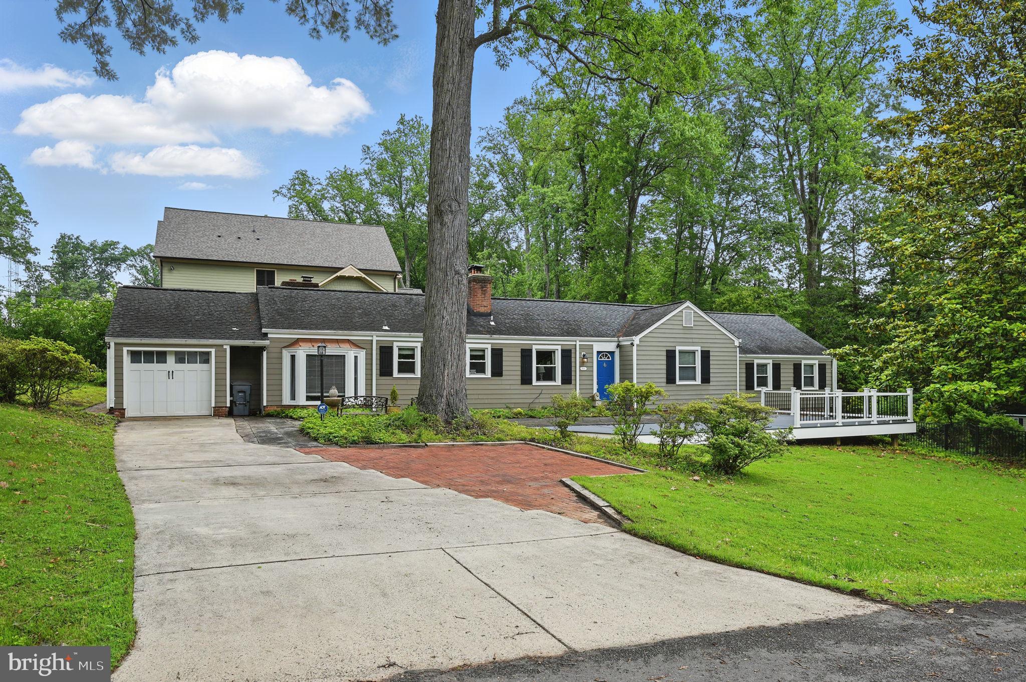 8536 Aponi Road Vienna, VA 22180 - Photo 2 of 40 a front view of a house with a yard and trees