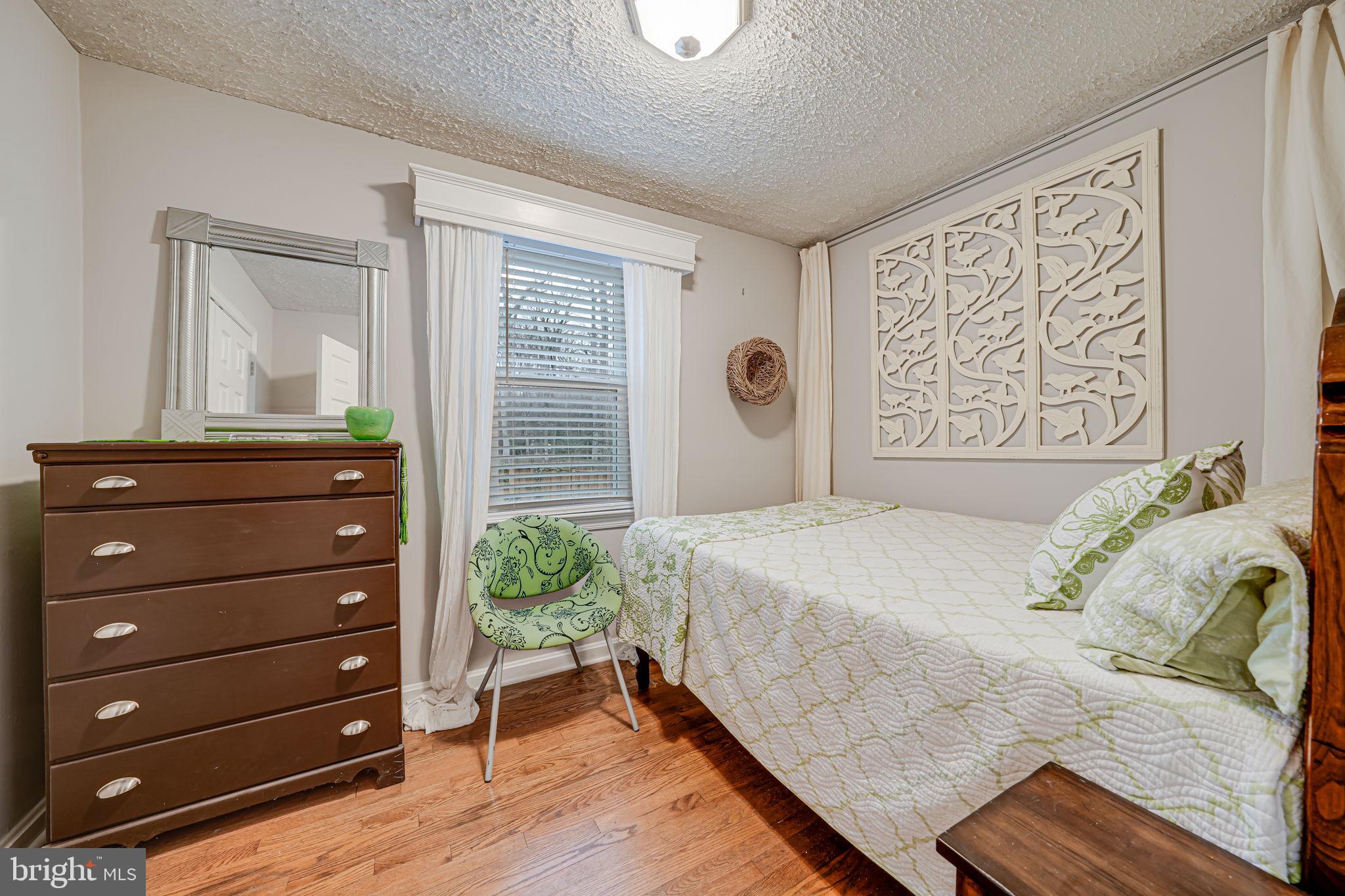 8536 Aponi Road Vienna, VA 22180 - Photo 23 of 40 a bedroom with a bed and a dresser