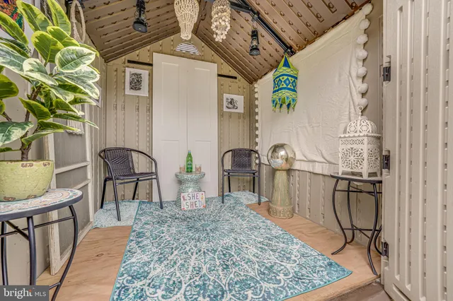 a view of a chairs and table in backyard of the house