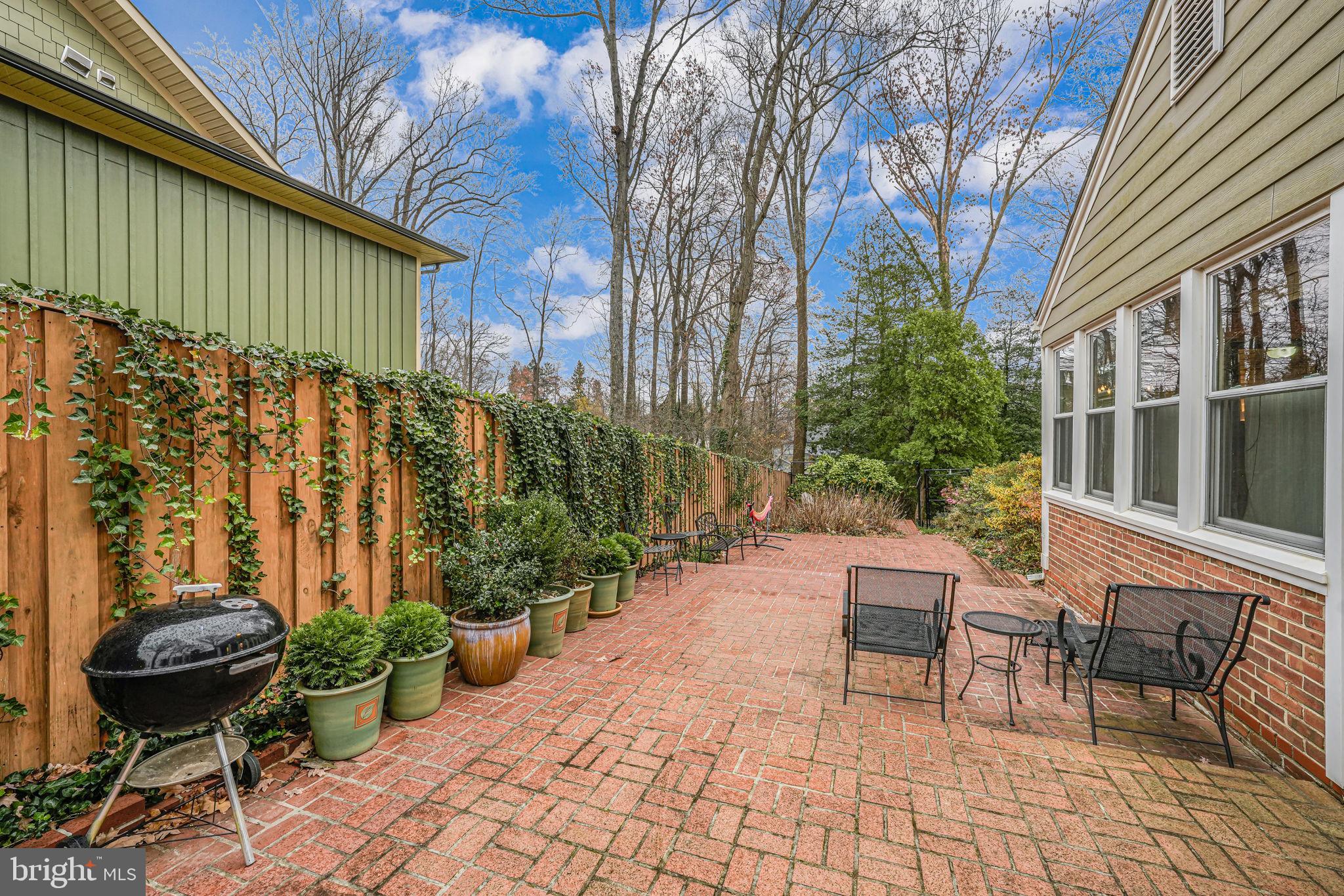 8536 Aponi Road Vienna, VA 22180 - Photo 31 of 40 a view of a chairs and table in backyard of the house
