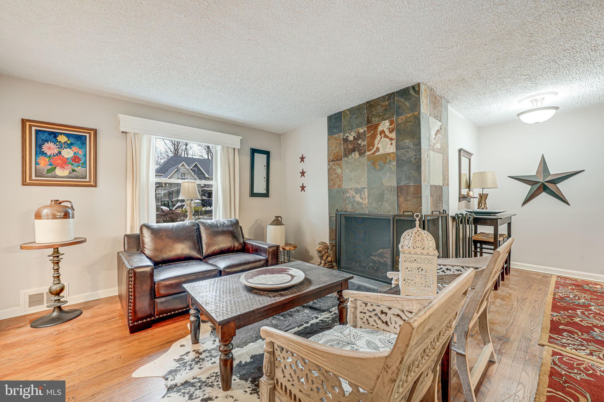 8536 Aponi Road Vienna, VA 22180 - Photo 4 of 40 a living room with furniture a rug and a window