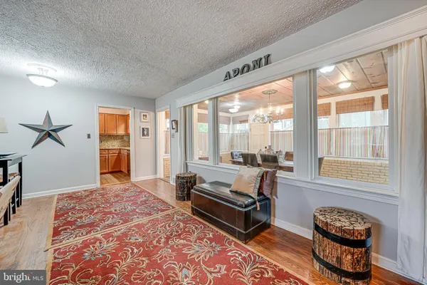 a living room with furniture and a floor to ceiling window