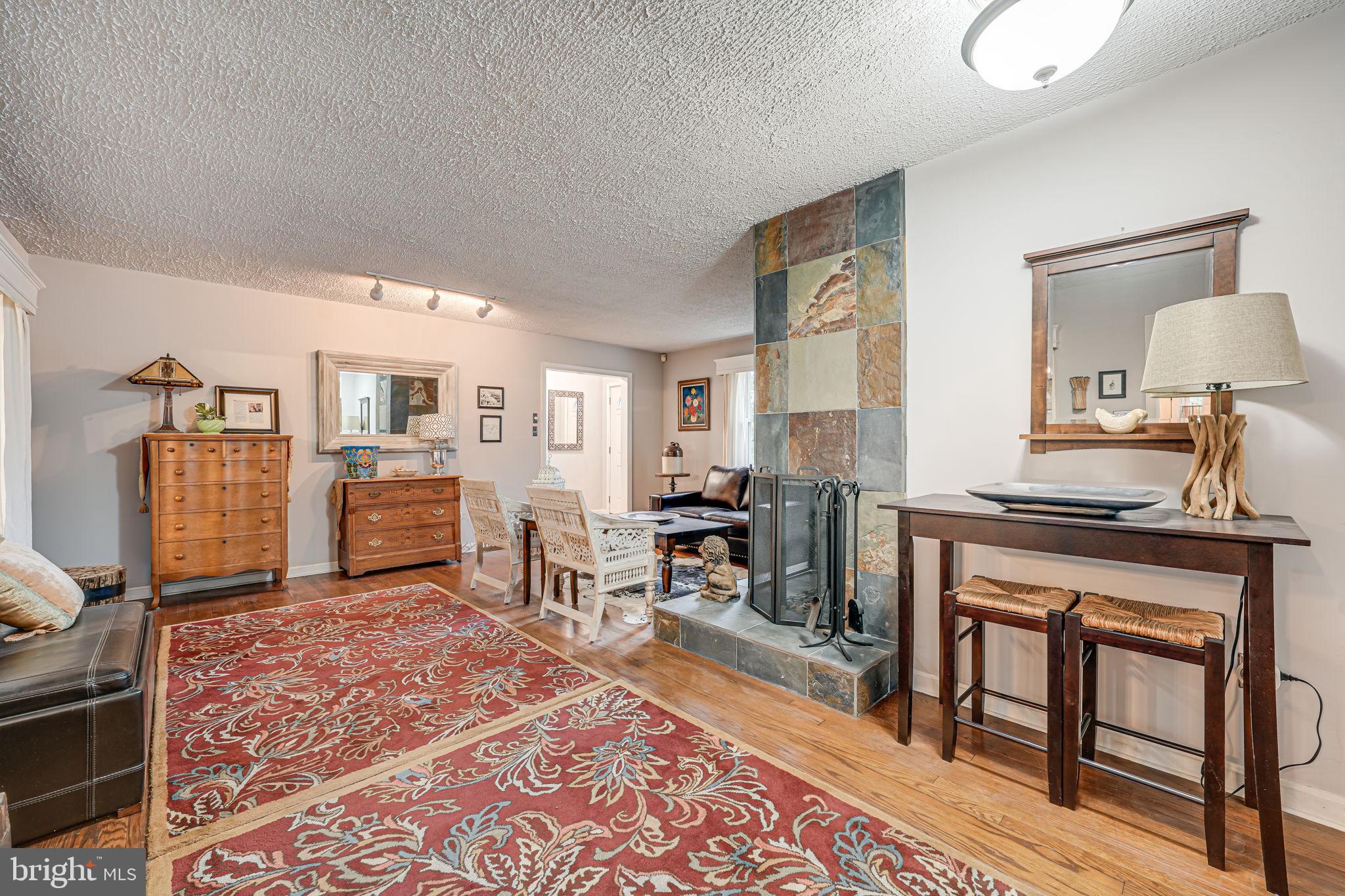 8536 Aponi Road Vienna, VA 22180 - Photo 6 of 40 a living room with furniture a rug and kitchen view